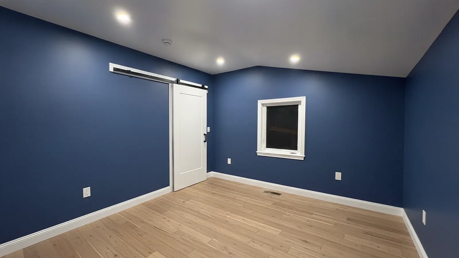 Navy bedroom with painted barn door