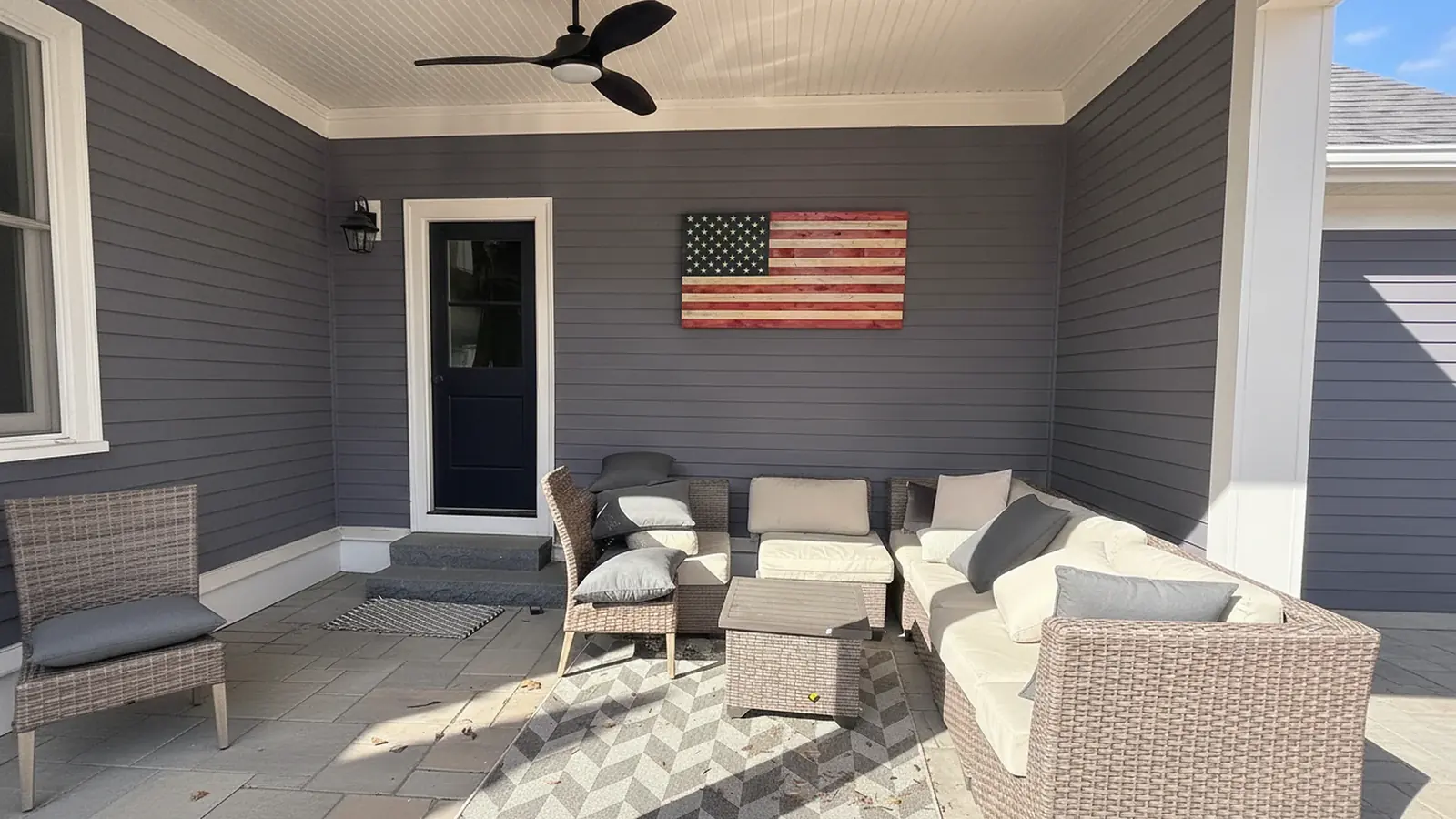 Painted front porch with white trim and a navy blue front door