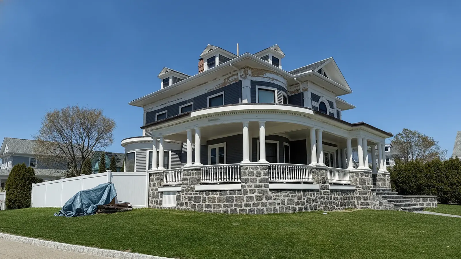 Victorian style house with a wraparound porch after exterior painting