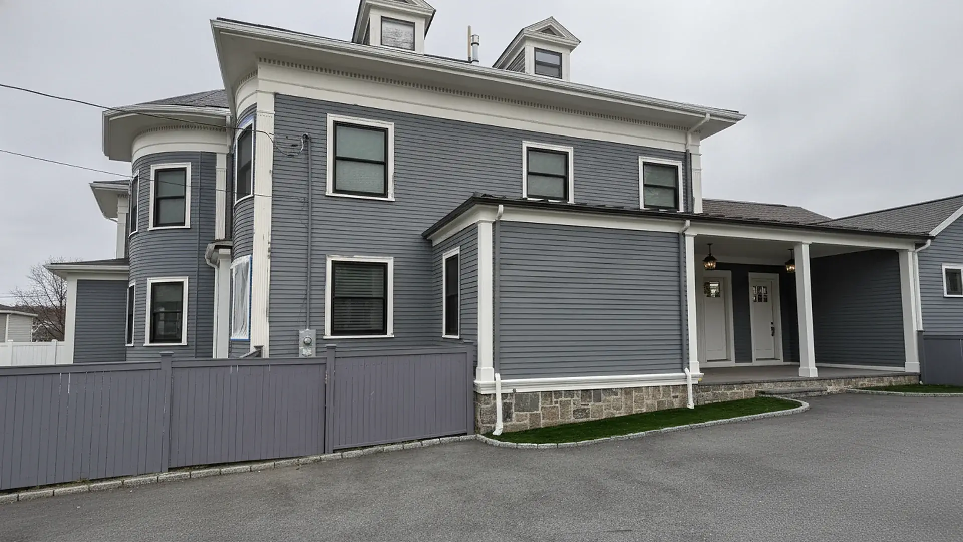 Gray colonial house with white trim, exterior painted by L&D Painting